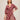 Woman wearing a red floral dress on a beige background