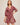 Woman wearing a red floral dress on a beige background