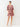Woman wearing a red and white patterned dress on a white background