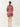 Woman wearing a red and white patterned dress on a white background