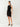 Woman wearing a black sleeveless dress on a white background
