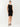 Woman wearing a black sleeveless dress on a white background