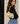 a woman wearing a gold leather shoulder bag