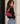 a woman wearing a burgundy leather purse
