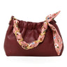 a leather clutch and crossbody purse on a white background