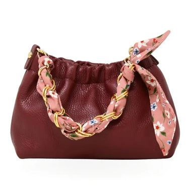 a leather clutch and crossbody purse on a white background