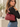 a woman wearing a leather purse