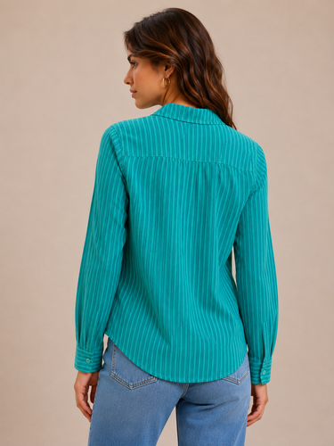 a green striped button down top and jeans