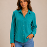 A woman wearing a green striped button down top