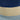 Close-up of a woven basket with blue, beige, and gray layers.