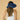 Woman wearing a blue visor on a beige background