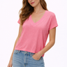 Woman wearing a pink t-shirt and blue jeans on a white background