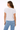 Woman wearing a white t-shirt and blue jeans on a white background