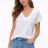 Woman wearing a white t-shirt and blue jeans on a white background