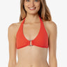 Woman wearing a red bikini top with a white background