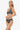 Woman wearing a black and white patterned bikini on a white background