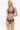 Woman wearing a black and white patterned bikini on a white background