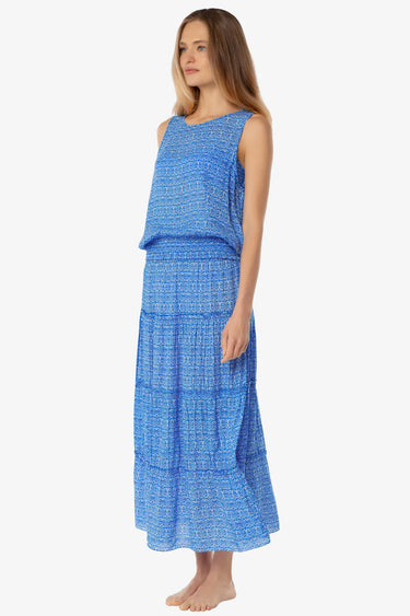 Woman wearing a blue patterned dress on a white background