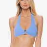 A woman wearing a textured halter swim top on a white background