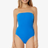 Woman wearing a blue strapless swimsuit on a white background