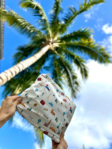 A medium white zipper pouch with world landmarks on it