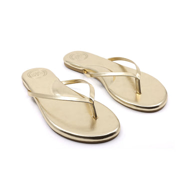 Pair of metallic gold flip-flops on a white background