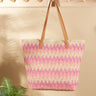 Woven tote bag with pink and green pattern on a beige background