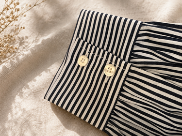A close up of a cotton stripe polo sleeve.
