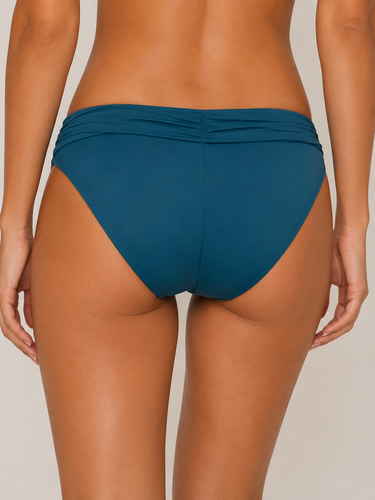 Teal bikini bottom worn by a women  on a neutral background