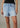 Light blue denim shorts worn by a person on a neutral background
