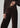 Chocolate brown button-front cardigan styled with matching wide-leg velvet pants and pointed-toe shoes on a model.