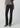 Black slim bootcut jeans styled with a metallic silver top and pointed-toe black heels on a model.