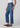Person wearing blue jeans on a white background