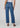 Person wearing mid rise ankle blue jeans on a plain background