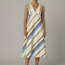 Woman wearing a striped dress on a plain background