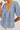 Blue barletta stripe blouse with a deep neckline on a white background