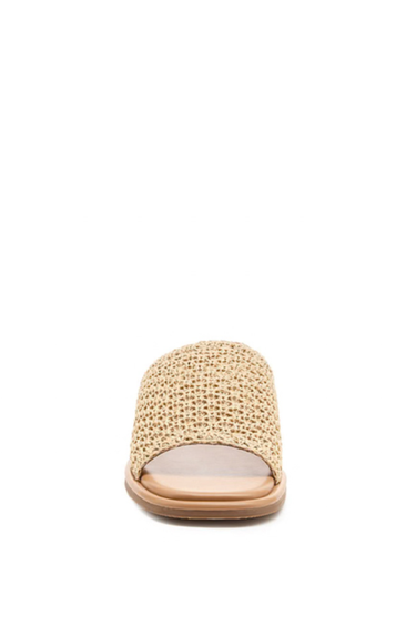 Beige sandal with textured strap on a white background