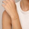 A woman wearing a dainty chain adjustable bracelet