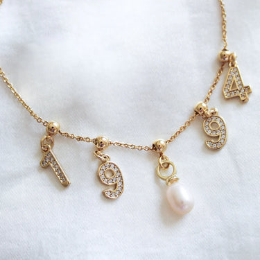 A charm bracelet on a neutral background 