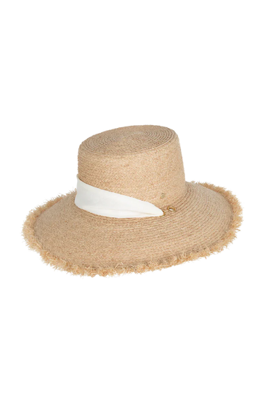 A natural straw hat with a tie on a neutral background