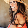 A woman wearing a natural wide brim sun hat