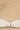 Close-up of a straw hat with a white ribbon and gold button.