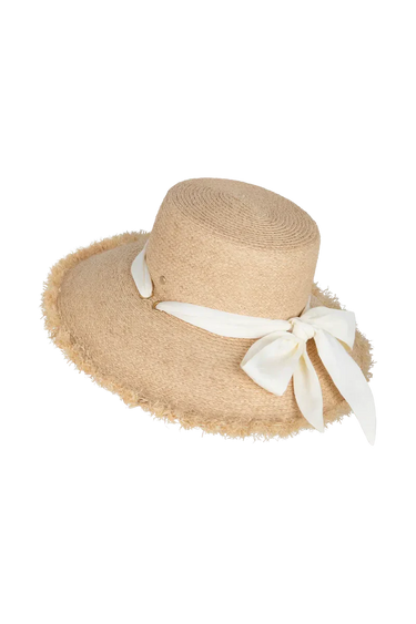 A natural straw hat with a tie on a neutral background