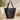A black leather tote bag on a table with aesthetic background 