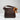 Brown leather handbag with a brown ribbon on a light gray background