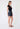 Woman wearing a black top and denim skirt on a white background