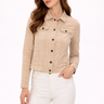 Woman wearing a beige jacket and white pants on a white background