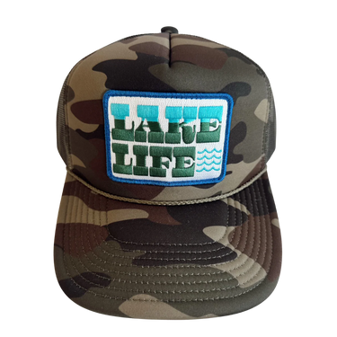 Camouflage cap with a 'Lake Life' patch on a white background