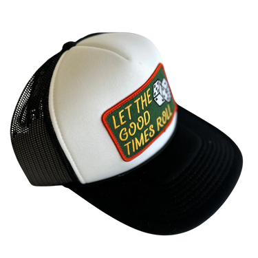 A black and white trucker hat with a green and yellow embroidered patch on the front that reads 'LET THE GOOD TIMES ROLL' with dice graphics, shown on a plain white background.