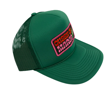 A green trucker hat with a mesh back and a front patch reading 'QUEEN OF MY LIFE' in orange and pink, shown on a plain white background.